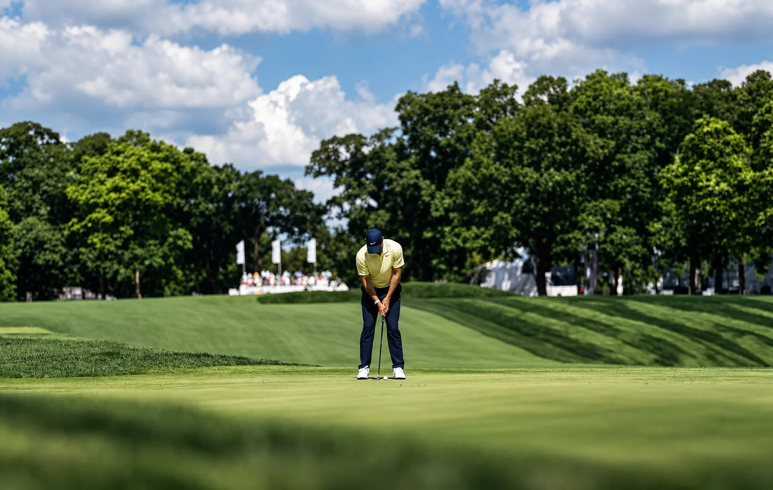 Golfer lining up a putt on the green
